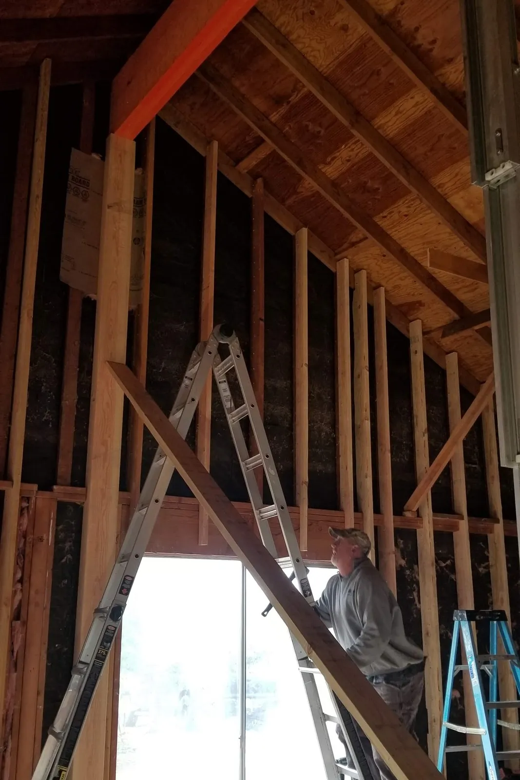 Temporary shoring supporting an opened roof structure during a CCI Builders beam repair